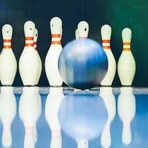 Bowling ball on a bowling alley rolling towards the bowling pins