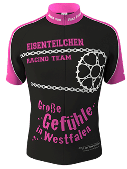 Zwarte fietsjersey met roze mouwen en een wit ketting- en kettingwielontwerp, met de tekst 'EISENTEILCHEN RACING TEAM' en 'Große Gefühle in Westfalen'.