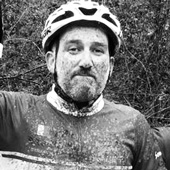 A man wearing a cycling helmet and a sports jacket from the brand 'owayo'.