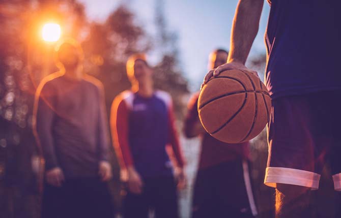 Basketball training: Man in basketball uniform holding ball in one hand