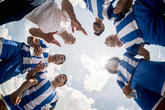 Coach instructs soccer team