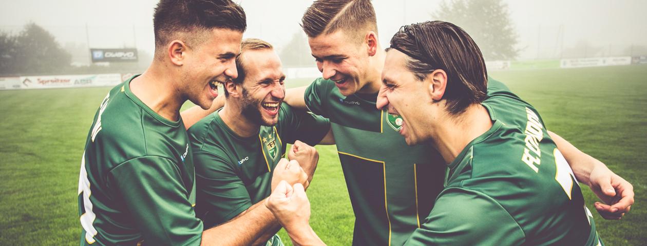 football players in green customized soccer jerseys celebrating