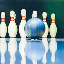 Bowling ball on a bowling alley rolling towards the bowling pins